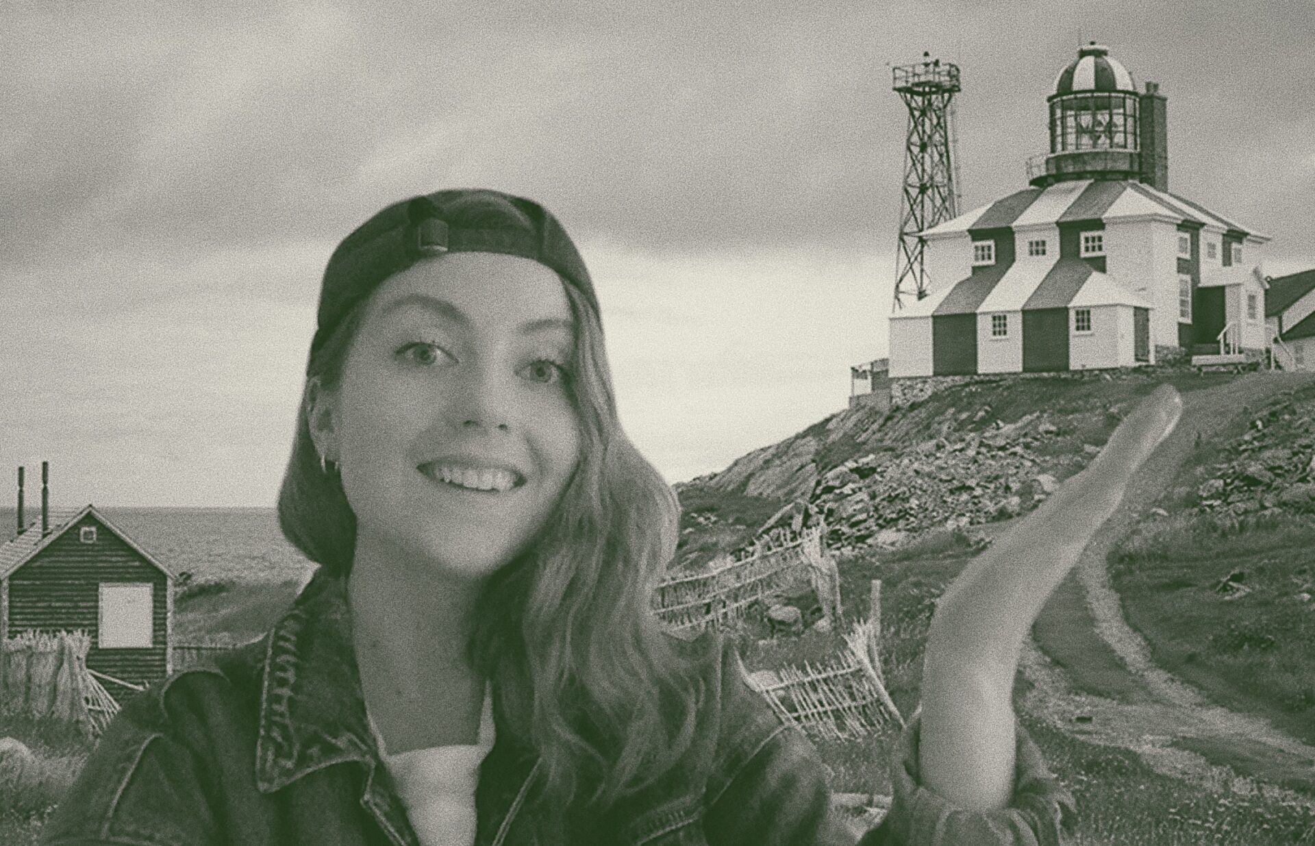 A woman points to a lighthouse.