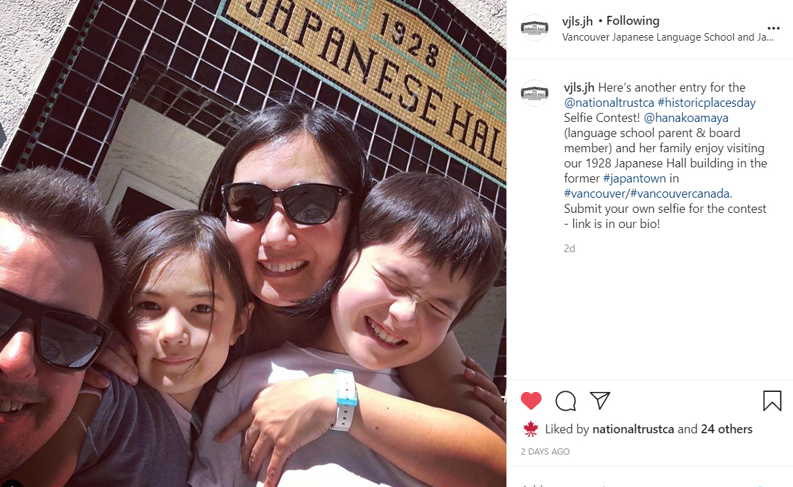 A family poses in front of an old building.