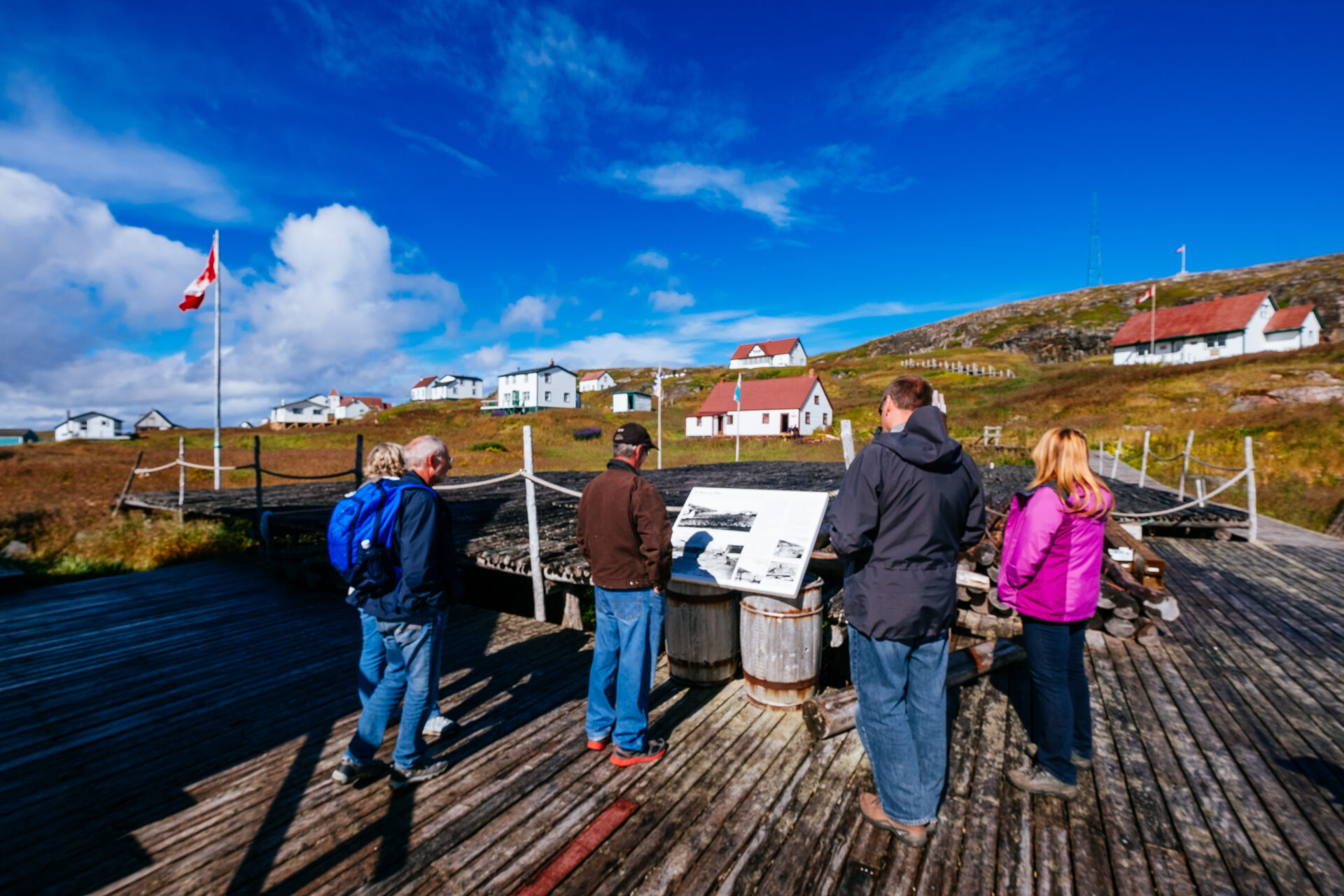 Visitors gather around for a tour at Battle Harbour, 
